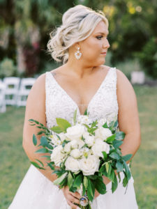 Bridal portrait of bride holding bouquet at a Channel Side Wedding in Palm Coast, Florida. Taken by Ashley Dye Photography, a Jacksonville, Florida Wedding Photographer.
