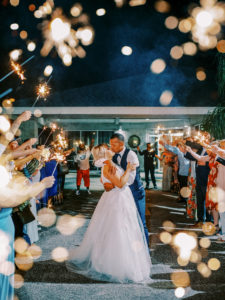 Bride and groom leave wedding with a sparkler exit at a Channel Side Wedding in Palm Coast, Florida. Taken by Ashley Dye Photography, a Jacksonville, Florida Wedding Photographer.