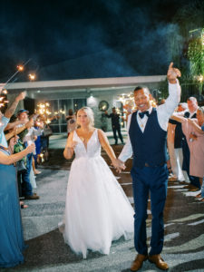 Bride and groom leave wedding with a sparkler exit at a Channel Side Wedding in Palm Coast, Florida. Taken by Ashley Dye Photography, a Jacksonville, Florida Wedding Photographer.