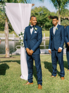 Groom sees bride coming down the aisle at a Channel Side Wedding in Palm Coast, Florida. Taken by Ashley Dye Photography, a Jacksonville, Florida Wedding Photographer.