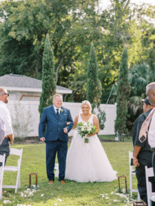 Father walking bride down the aisle at a Channel Side Wedding in Palm Coast, Florida. Taken by Ashley Dye Photography, a Jacksonville, Florida Wedding Photographer.
