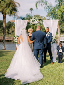 Father walk daughter to end of the end of the aisle at a Channel Side Wedding in Palm Coast, Florida. Taken by Ashley Dye Photography, a Jacksonville, Florida Wedding Photographer.