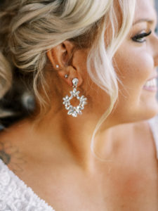 Close up shot of bride's earring at her Channel Side Wedding in Palm Coast, Florida. Taken by Ashley Dye Photography, a Jacksonville, Florida Wedding Photographer.